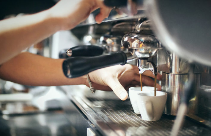 Barista pulls fresh espresso shots made with filtered water.
